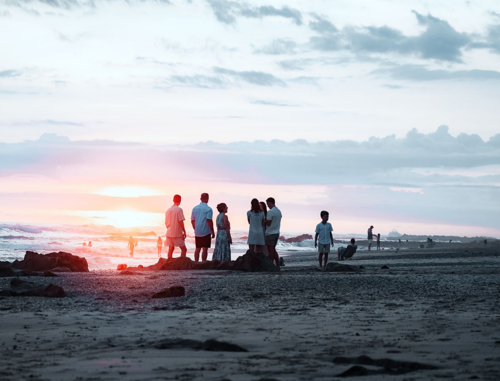 Retreat group watching the sunset on the beach at Trópico Latino in Santa Teresa, Costa Rica