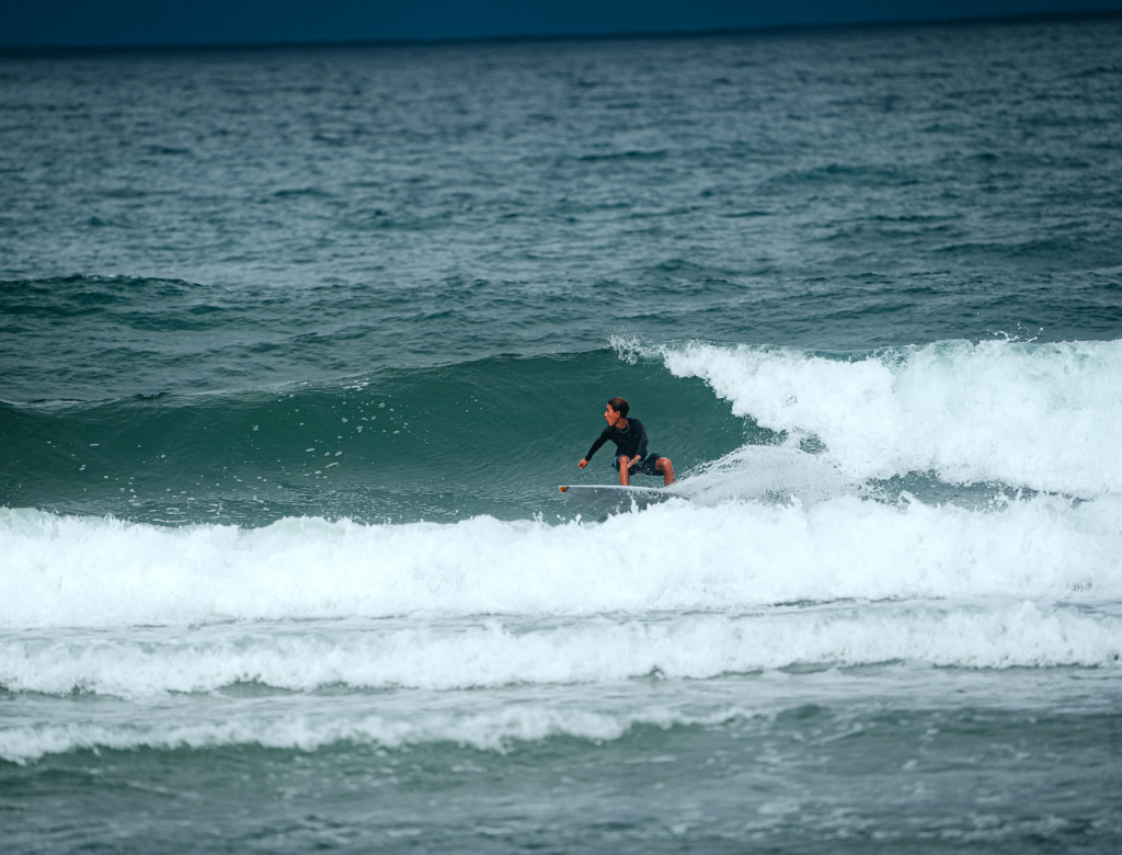 Surfer riding waves in Santa Teresa, Costa Rica